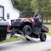 Farmer loading ATV with MAD-RAMPS onto pickup truck