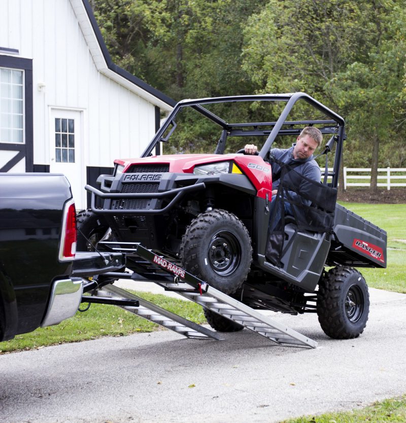 Farmer loading ATV with MAD-RAMPS onto pickup truck