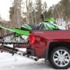 snowmobile loaded on truck with mad ramps