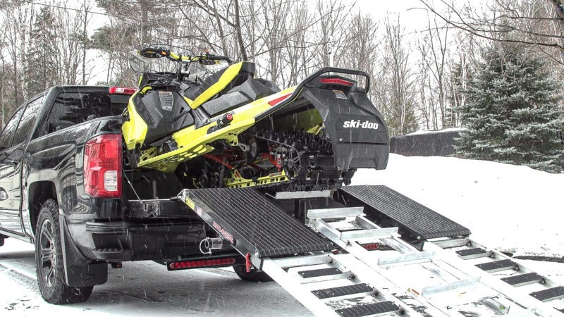 snowmobile loaded on truck with mad ramps