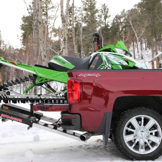 snowmobile loaded in vehicle with mad ramps loading system