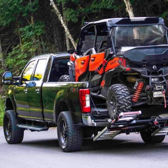 four passenger UTV loaded on a truck bed with MADRAMPS in drive position