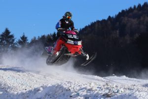 snowmobile rider jumping snowmobile outdoors