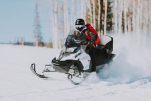 photo of man riding one of the fastest snowmobiles